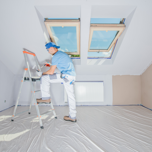 A man painting the interior of a house